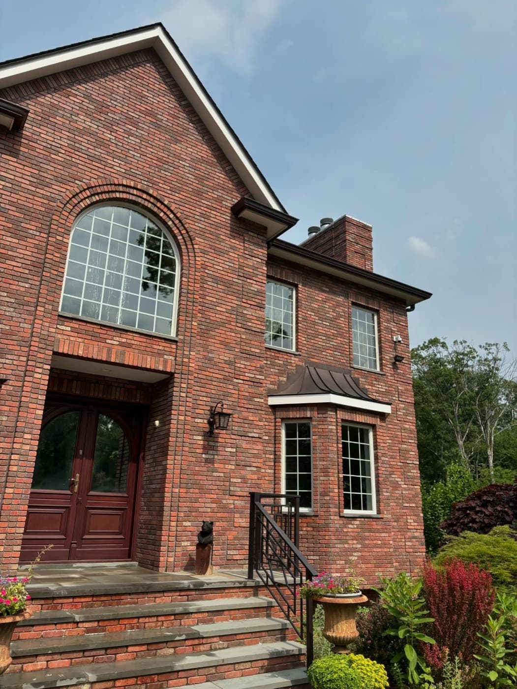Brick colonial with an arched window, freshly cleaned